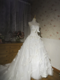 White strapless ball gown with a cinched waist and a voluminous puffy skirt; bridal gown R7291