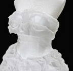 White strapless ball gown with a cinched waist and a voluminous tiered cake skirt; bridal gown R7300