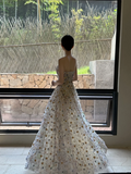 Sheer white base with appliqué, strapless, waist‑cinched, slim‑fit, long ball gown with a voluminous ruffled skirt R8015