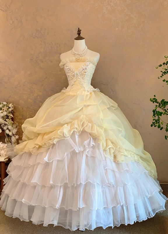 Light yellow strapless ball gown with a cinched waist and a voluminous puffy skirt; bridal gown R7308