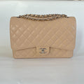 Chanel beige caviar quilted leather maxi double flap bag