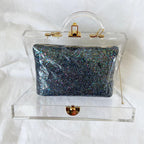 Charlotte Olympia clear acrylic box clutch with blue glittery zip pouch